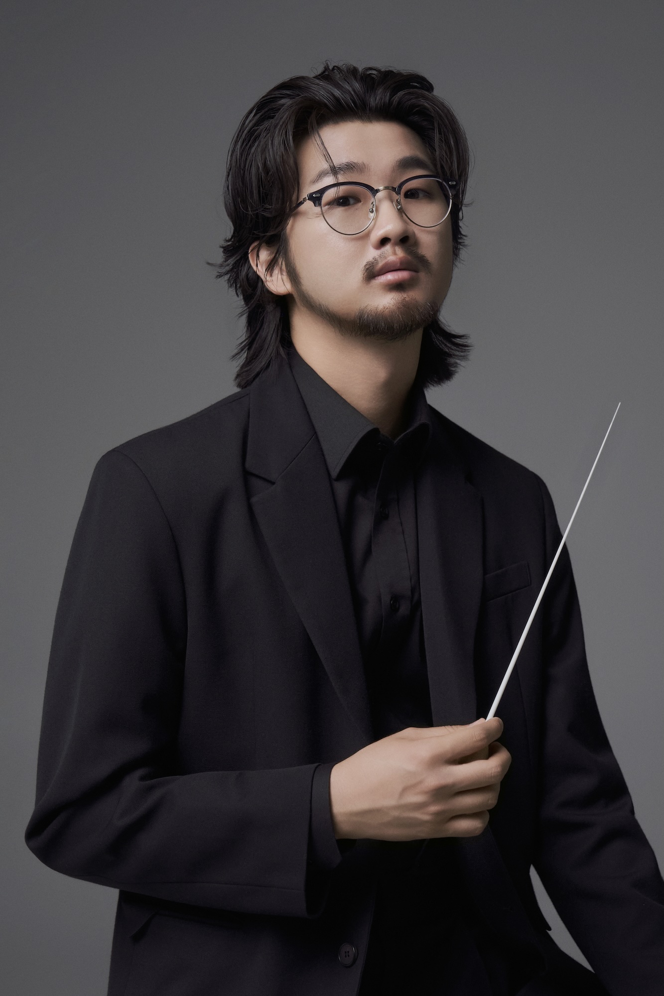 Eric B.J Kim holding a baton