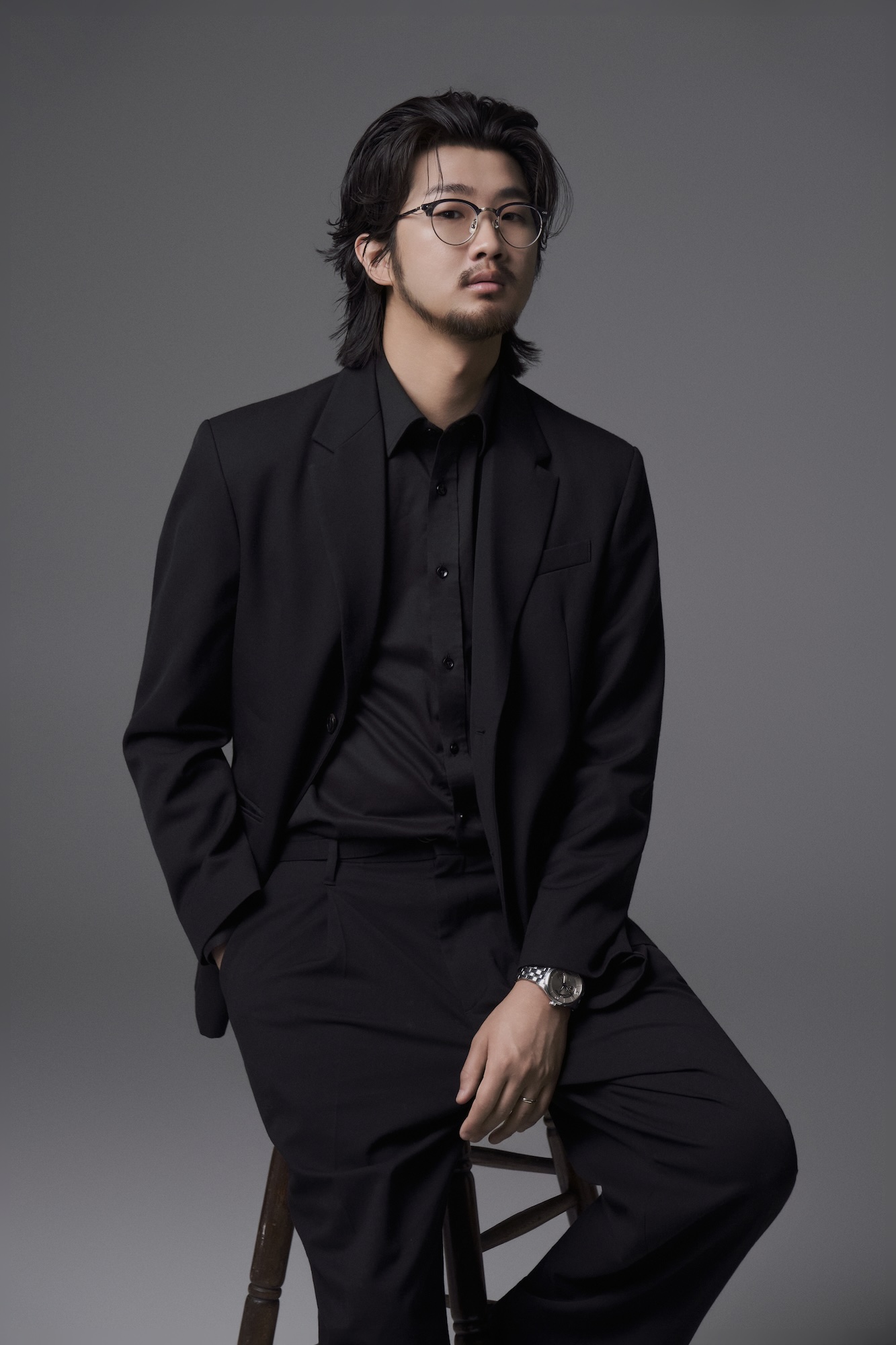 Eric B.J Kim seated with baton